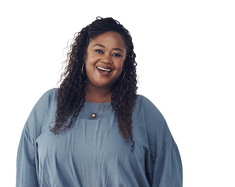 Woman standing arms down smiling.