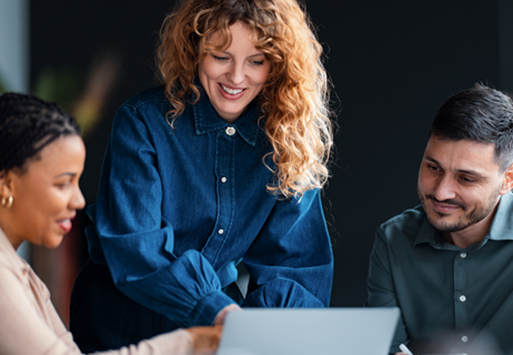 Three people looking at laptop